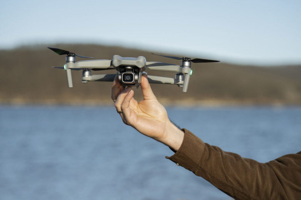 DJI Mavic 4 Pro: The Triple-Camera Drone That’s Changing the Game 1 man s hand holding drone outdoors
