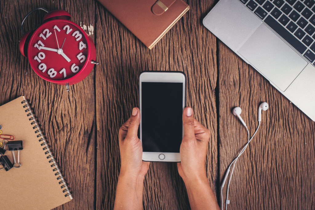 Apple Stops Signing iOS 18.4.1: No More Downgrades Allowed 1 top view phone workspace wood background