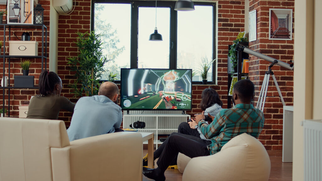 How YouTube TV Is Transforming the Streaming Experience in 2025 1 diverse people having fun with video games online tv console playing gaming competition challenge using gameplay enjoy gathering with friends home drinking beer
