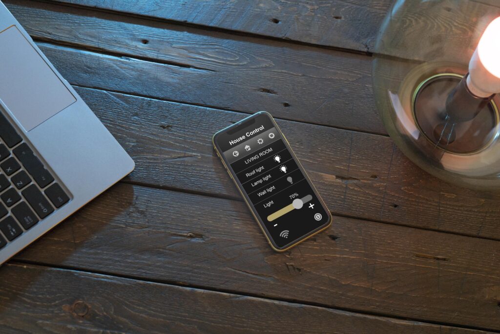 iOS 26’s Game-Changing Battery Upgrade: Full iPhone Compatibility List 2 man controlling smart lamp with his phone