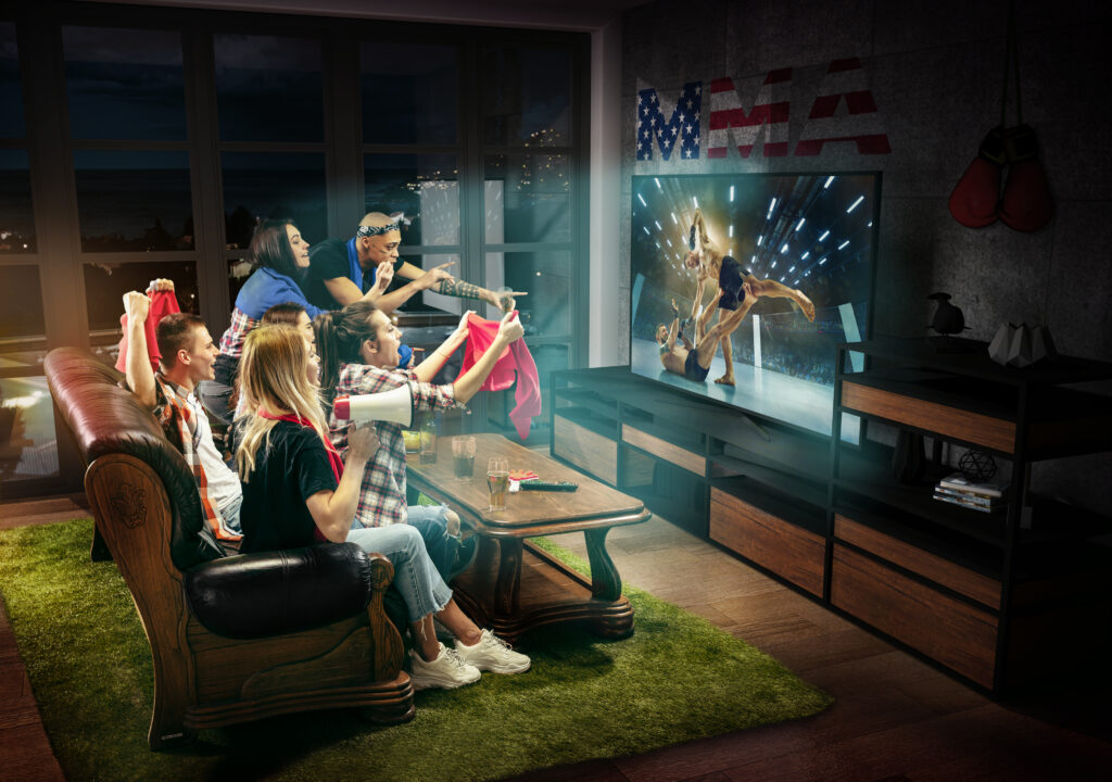 Ultimate Independence Day Movie Marathon: Set the Scene with the Best TVs and Projectors 2 group friends watching tv mma fight usa sport games
